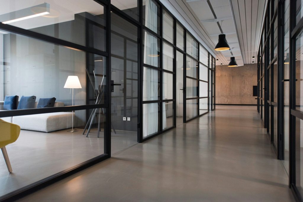 Modern commercial office interior with glass partitions and minimalist design